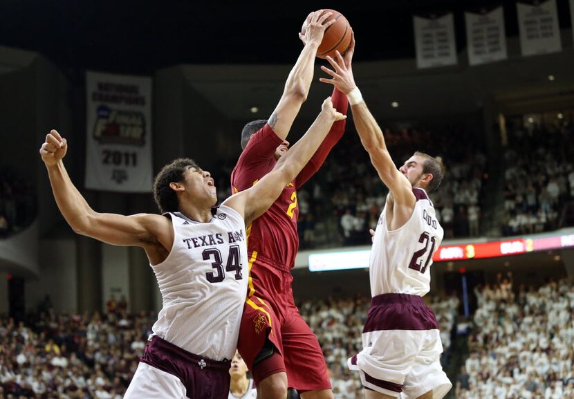 Iowa State's Abdel Nader (2) grabs a rebound from Texas A&M's Tyler Davis (34) and Alex...