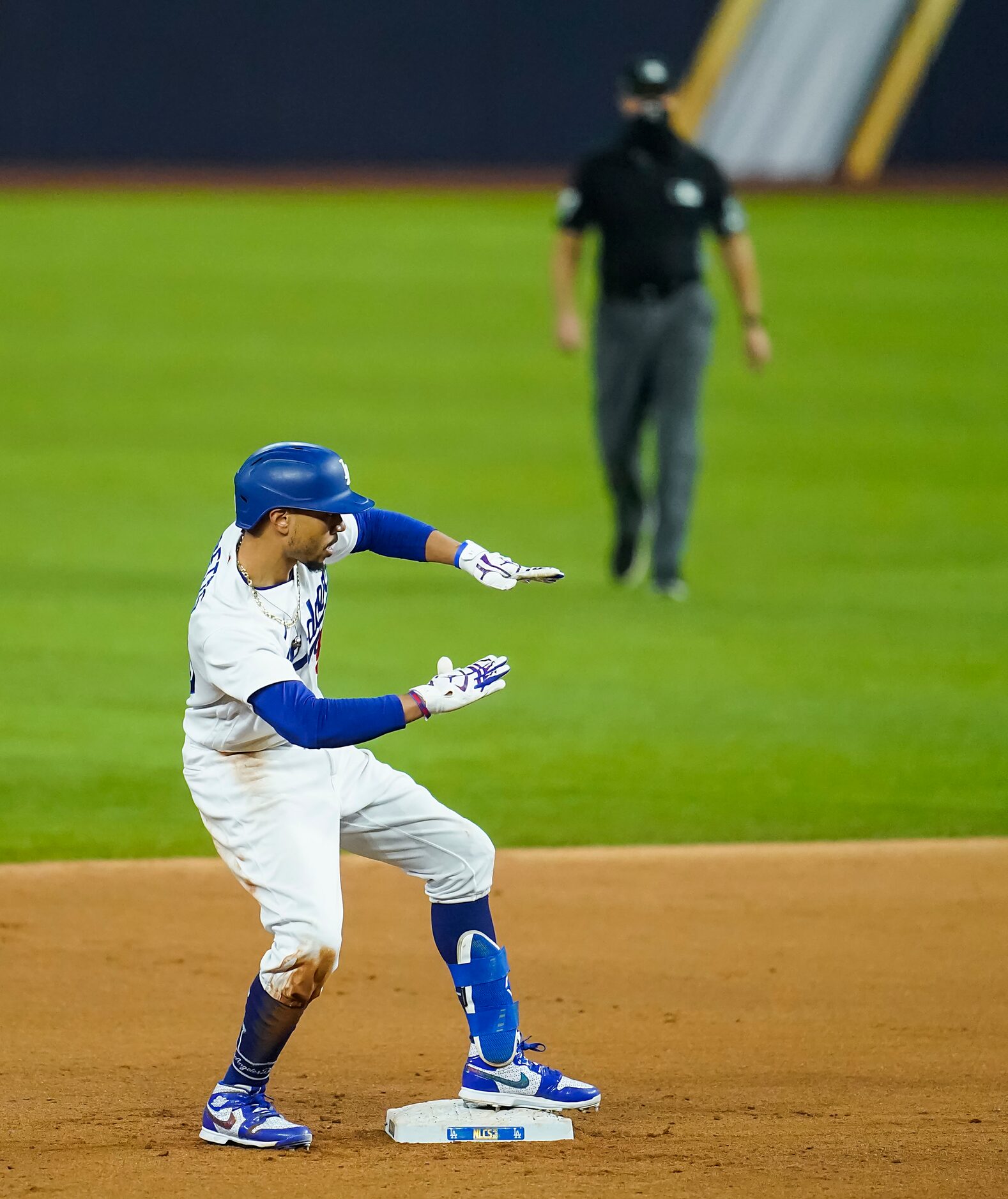 Los Angeles Dodgers right fielder Mookie Betts celebrates after hitting a double during the...