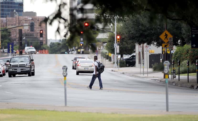 A pedestrian crosses Young Street in front of First Presbyterian Church of Dallas where one...