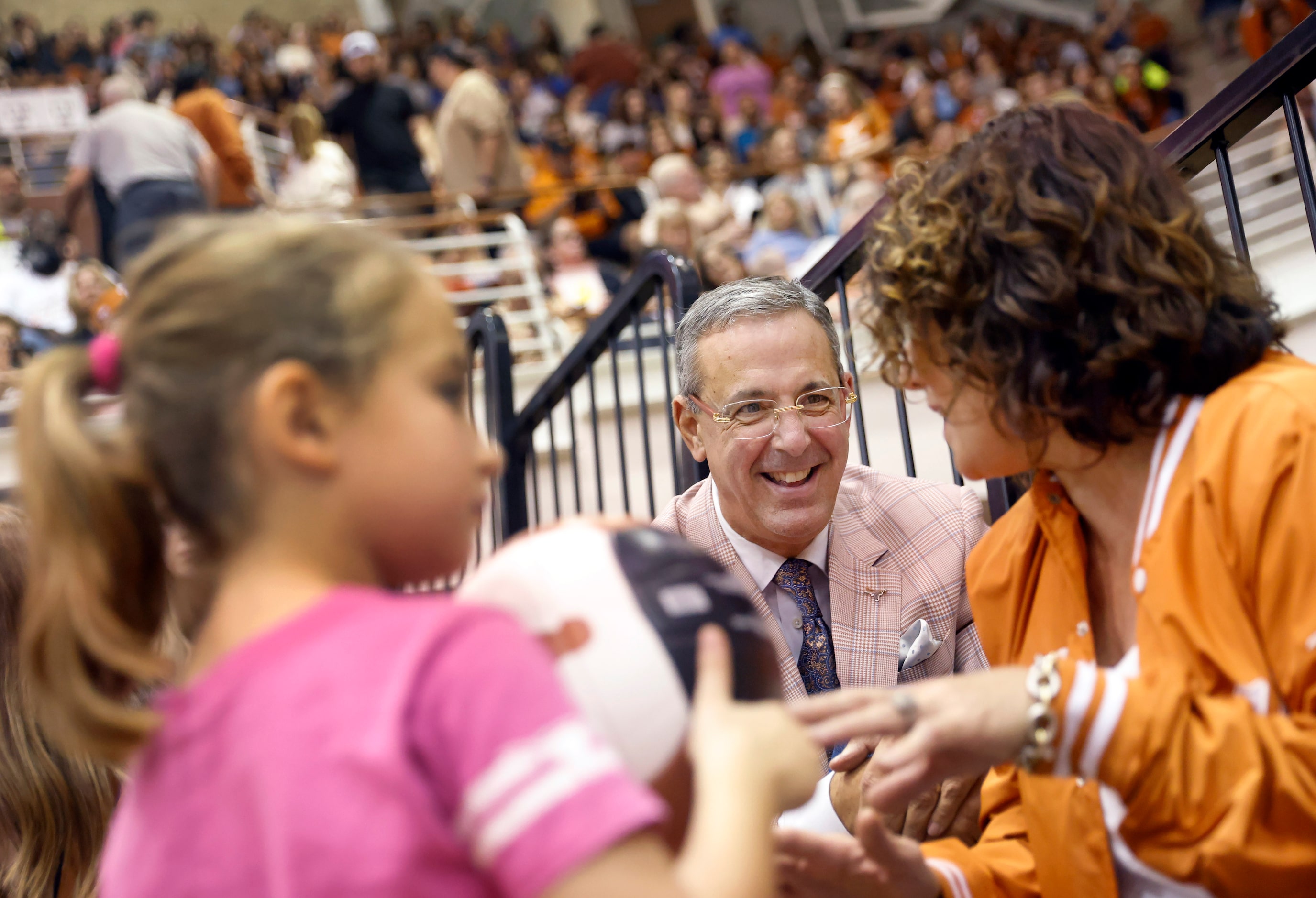 University of Texas Athletic Director Chris Del Conte (center) visits with friend Pascha...