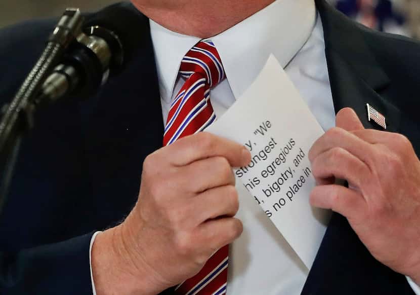 President Donald Trump reached into his suit jacket for a piece of paper with the quote he...