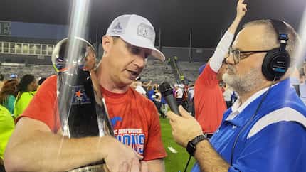 SMU coach Rhett Lashlee speaks to reporters while clutching the American Athletic Conference...