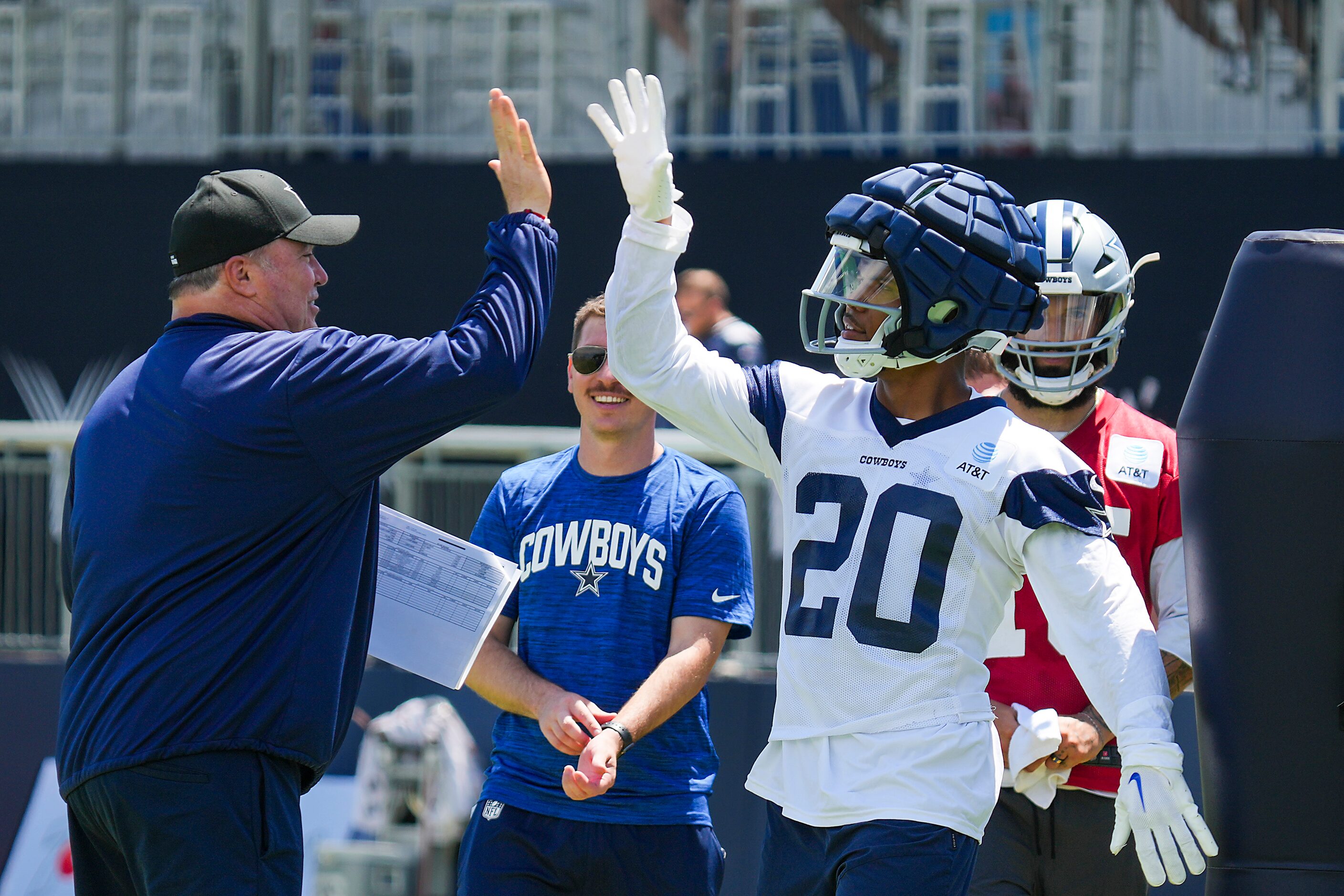 Dallas Cowboys running back Tony Pollard (20) high fives head coach Mike McCarthy during the...