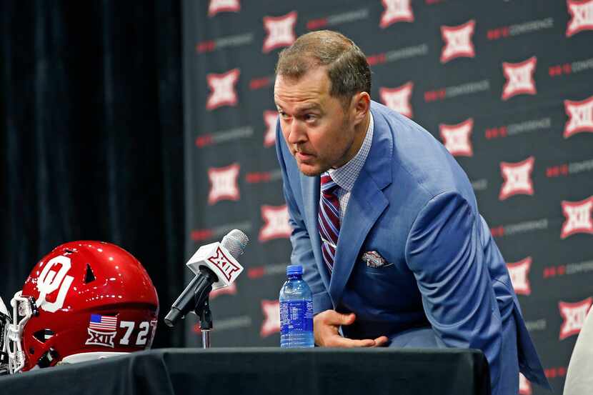 Oklahoma head football coach Lincoln Riley takes a seat during a press conference in Big 12...