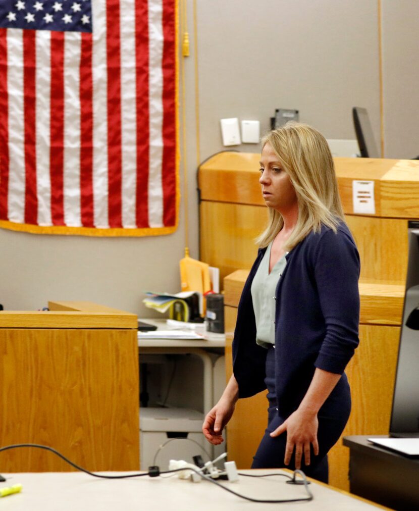 Fired Dallas police Officer Amber Guyger walks out of the courtroom after a jury found her...