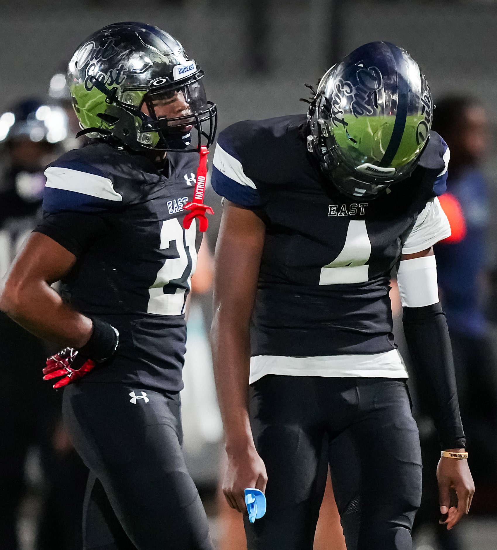 Wylie East quarterback Howard Fisher IV (4) and running back  Michael Henderson III (21)...