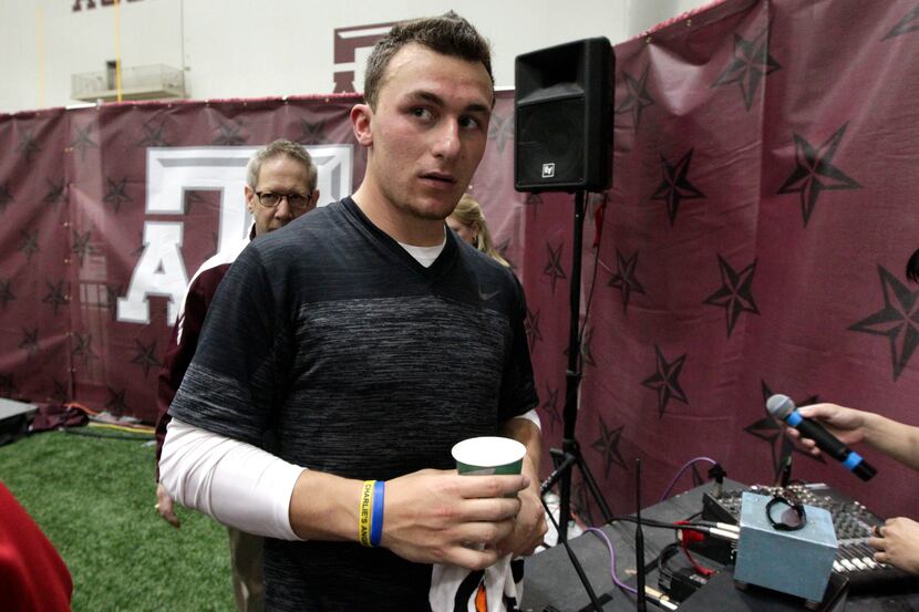 Texas A&M quarterback Johnny Manziel leaves the McFerrin Athletic Center after pro day for...