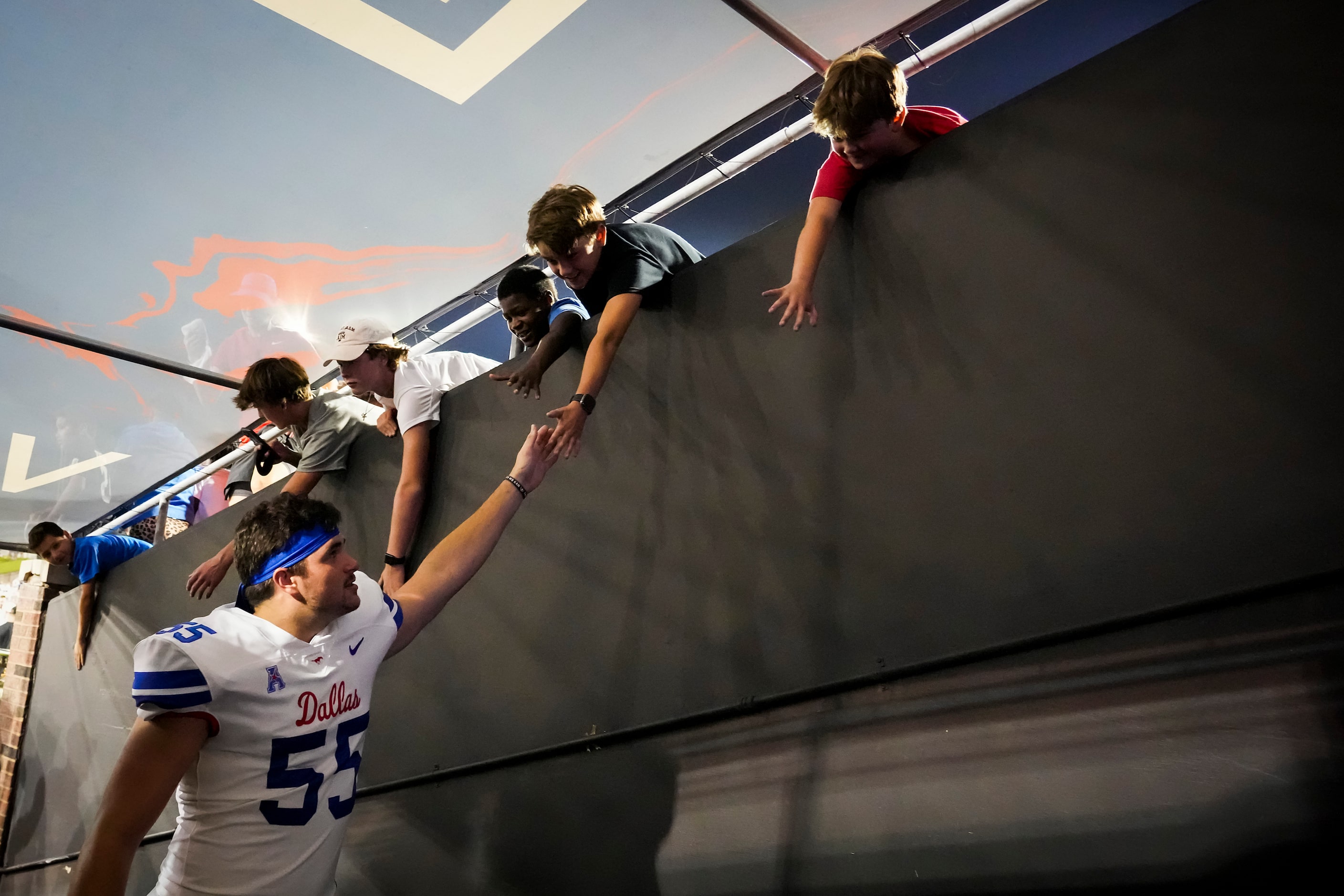 SMU defensive tackle Dylan Frazier (55) celebrates with fans as he leaves the field after a...