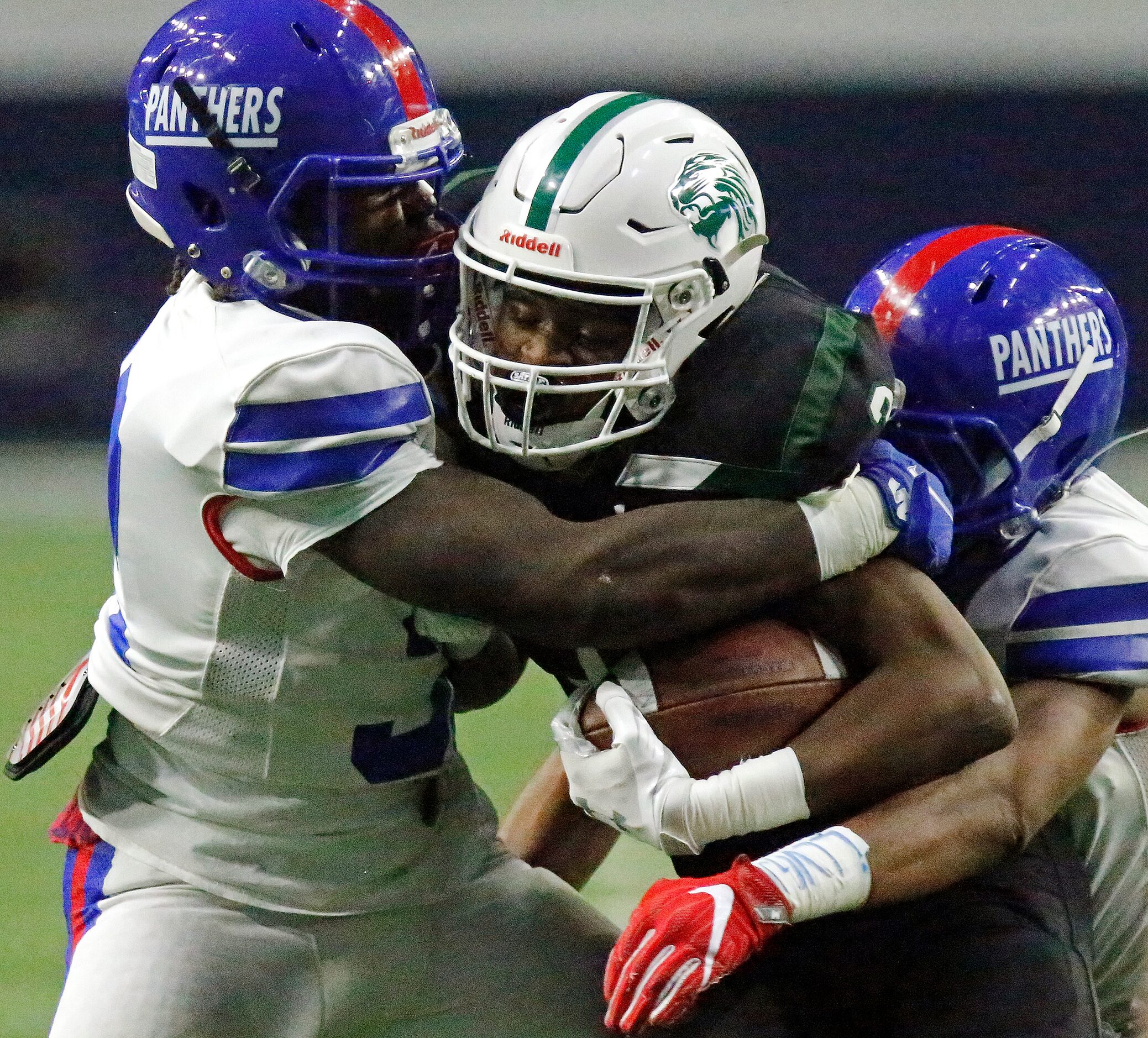 Spring High School wide receiver Cadyn Bradley (3) is sandwiched between Duncanville High...