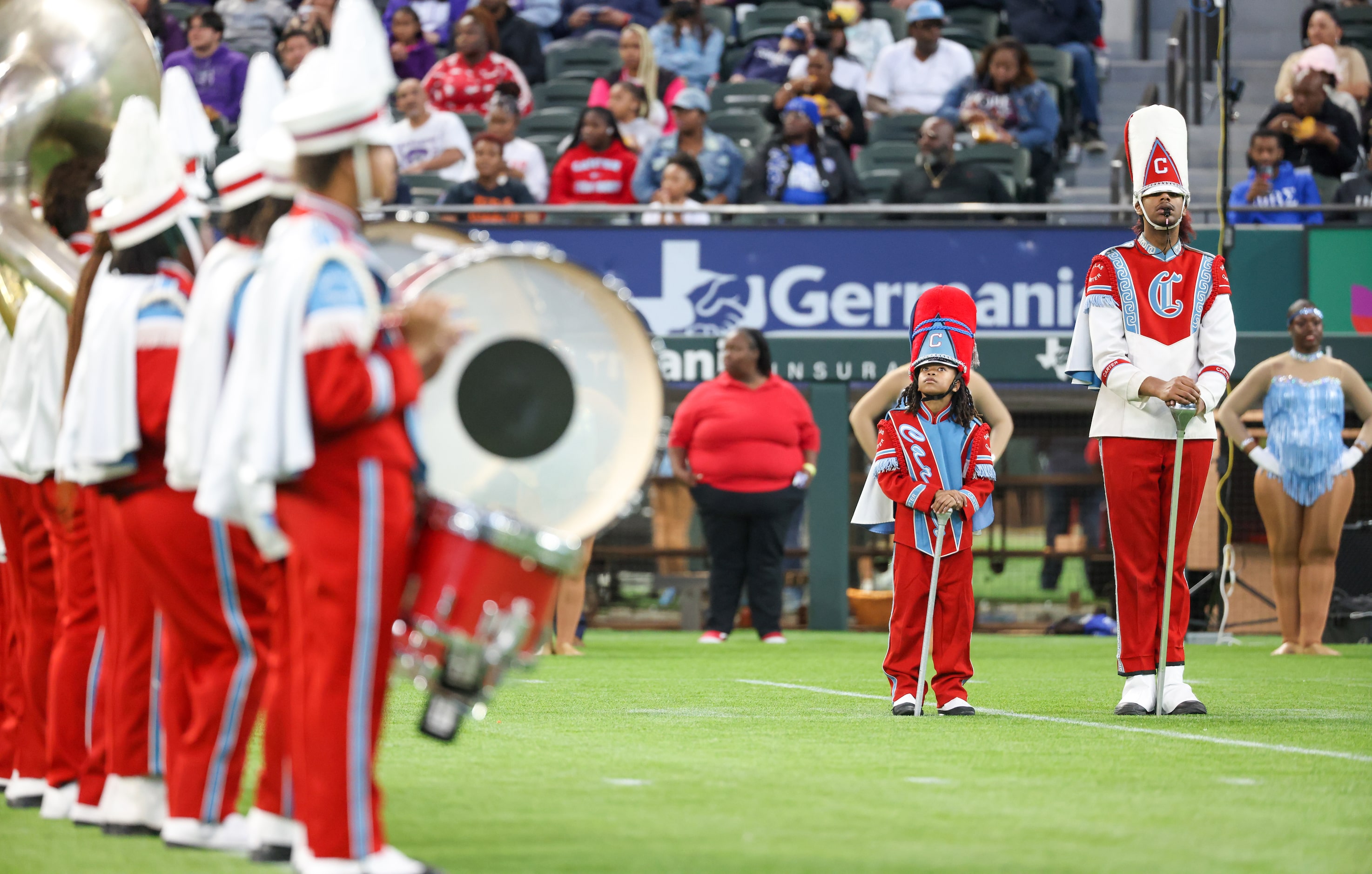 Prince Wade (left) looks up at the big screen before performing with the Carter High School...