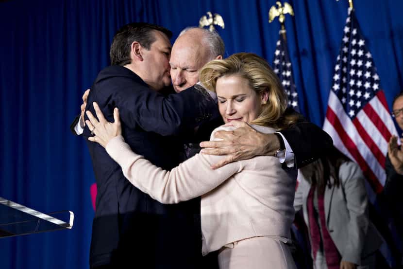  Texas Sen. Ted Cruz embraces his father, Rafael Cruz, and wife Heidi after suspending his...