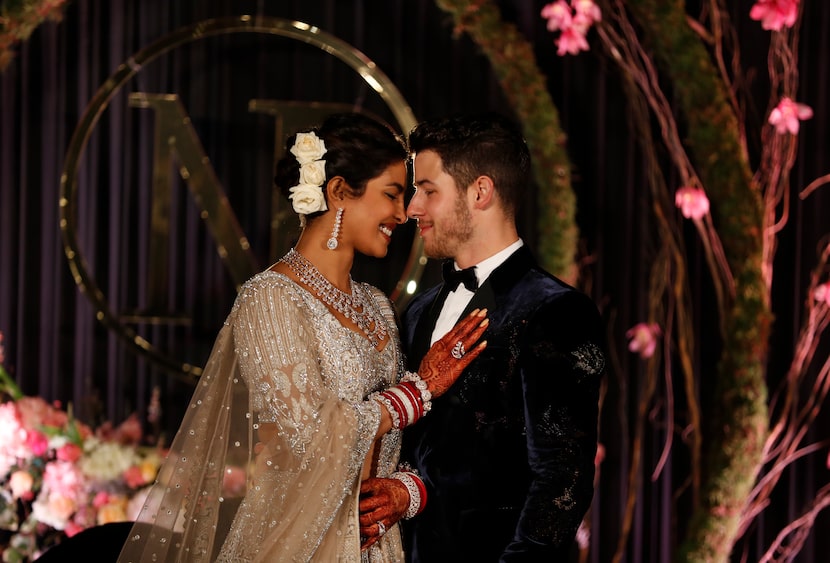 Bollywood actress Priyanka Chopra and musician Nick Jonas stand for photographs at their...