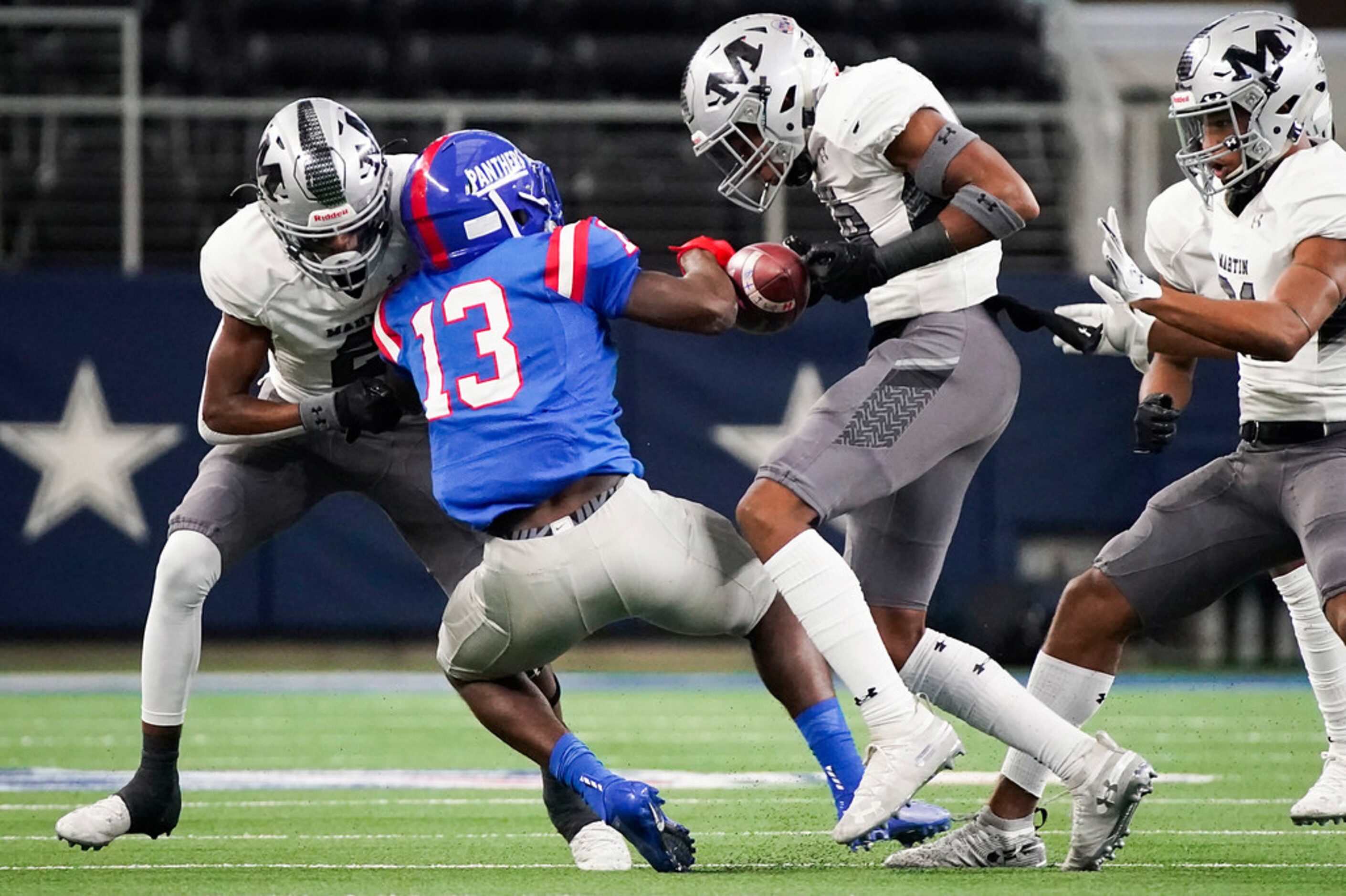 Arlington Martin linebacker  Morice Blackwell, Jr. strips the ball away from Duncanville...