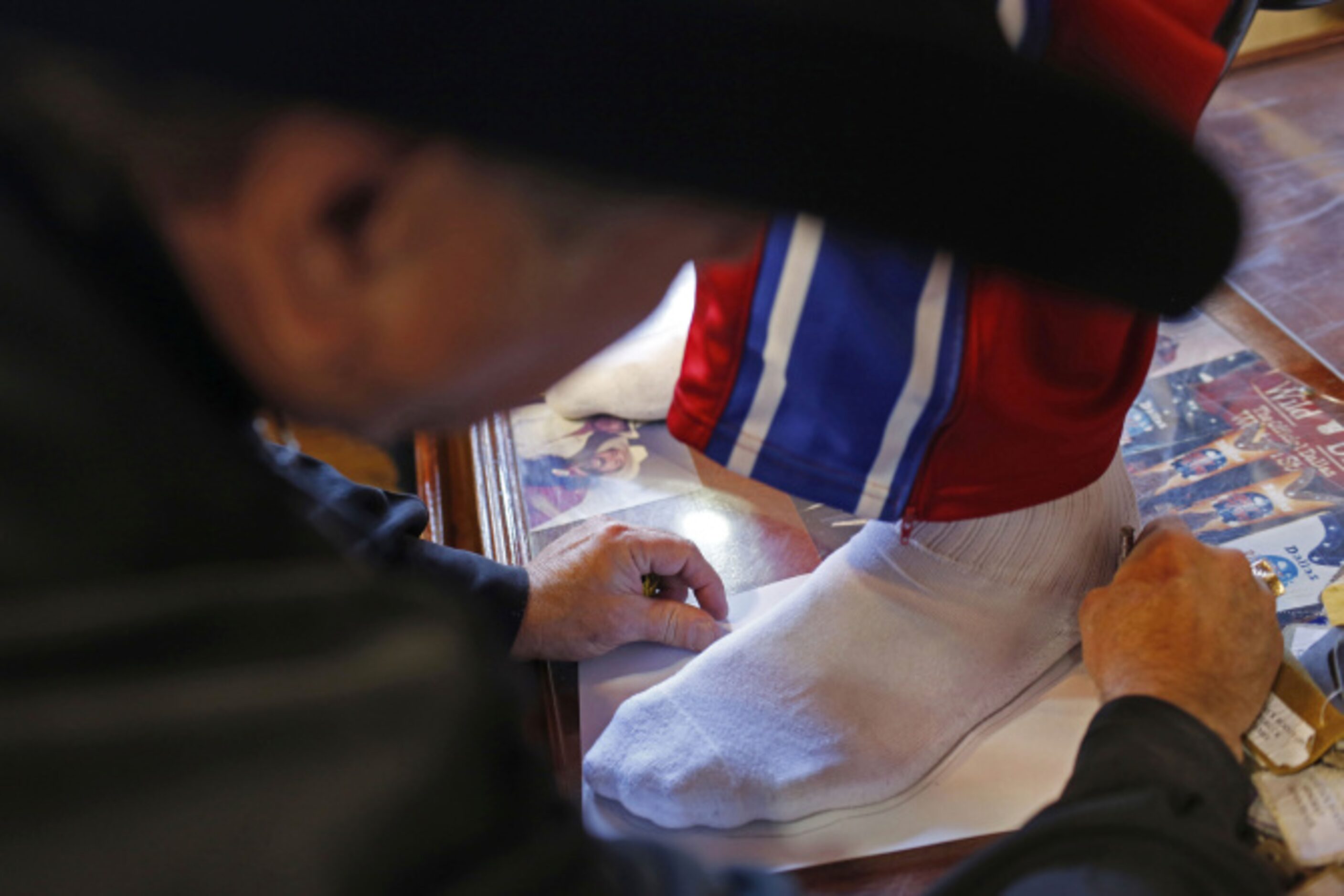 Bill Dewbre, store owner, fits Harlem Globetrotter Paul "Tiny" Sturgess for a pair of cowboy...