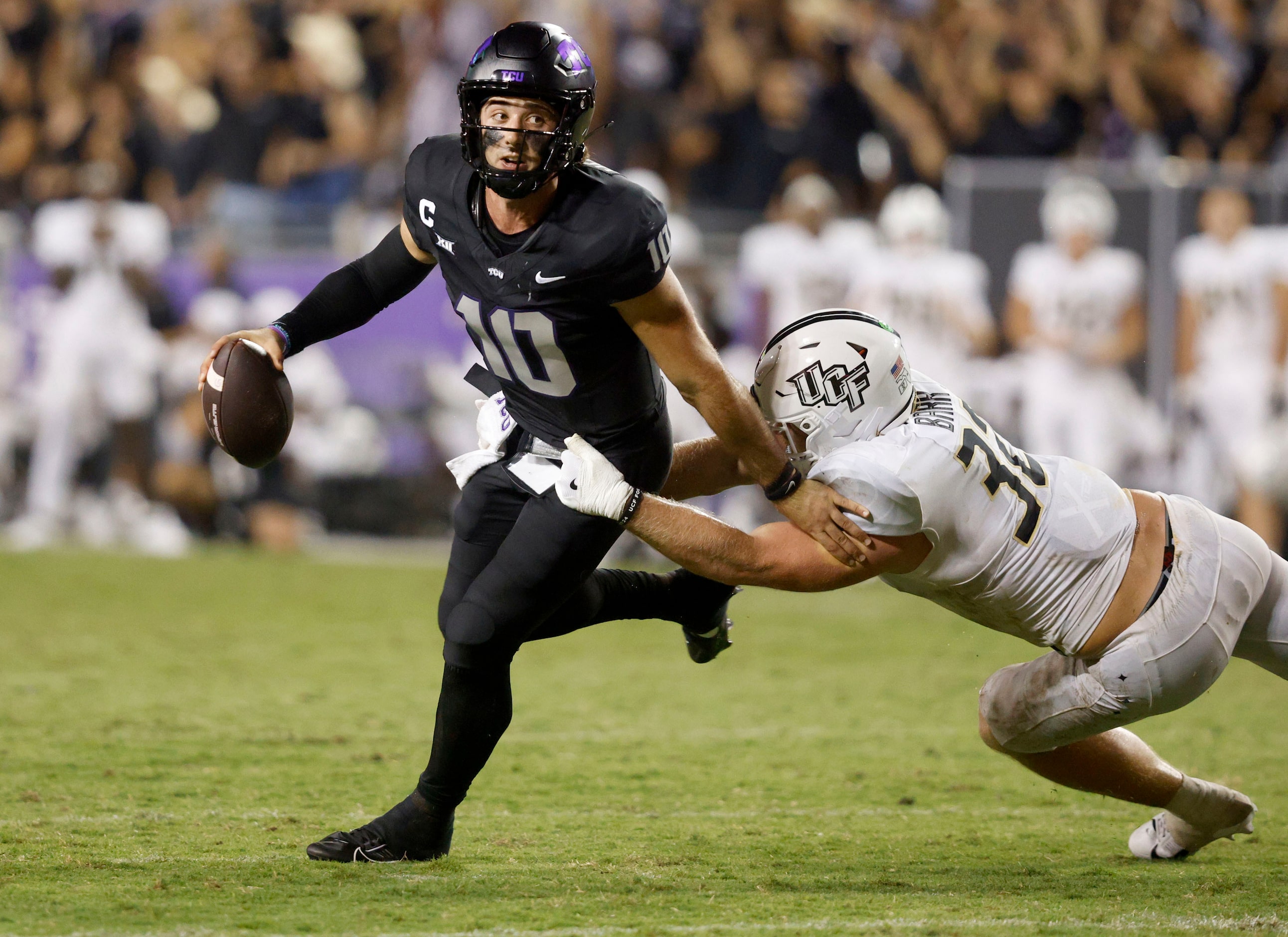 TCU quarterback Josh Hoover (10) is tackled by UCF linebacker Ethan Barr (32) during the...