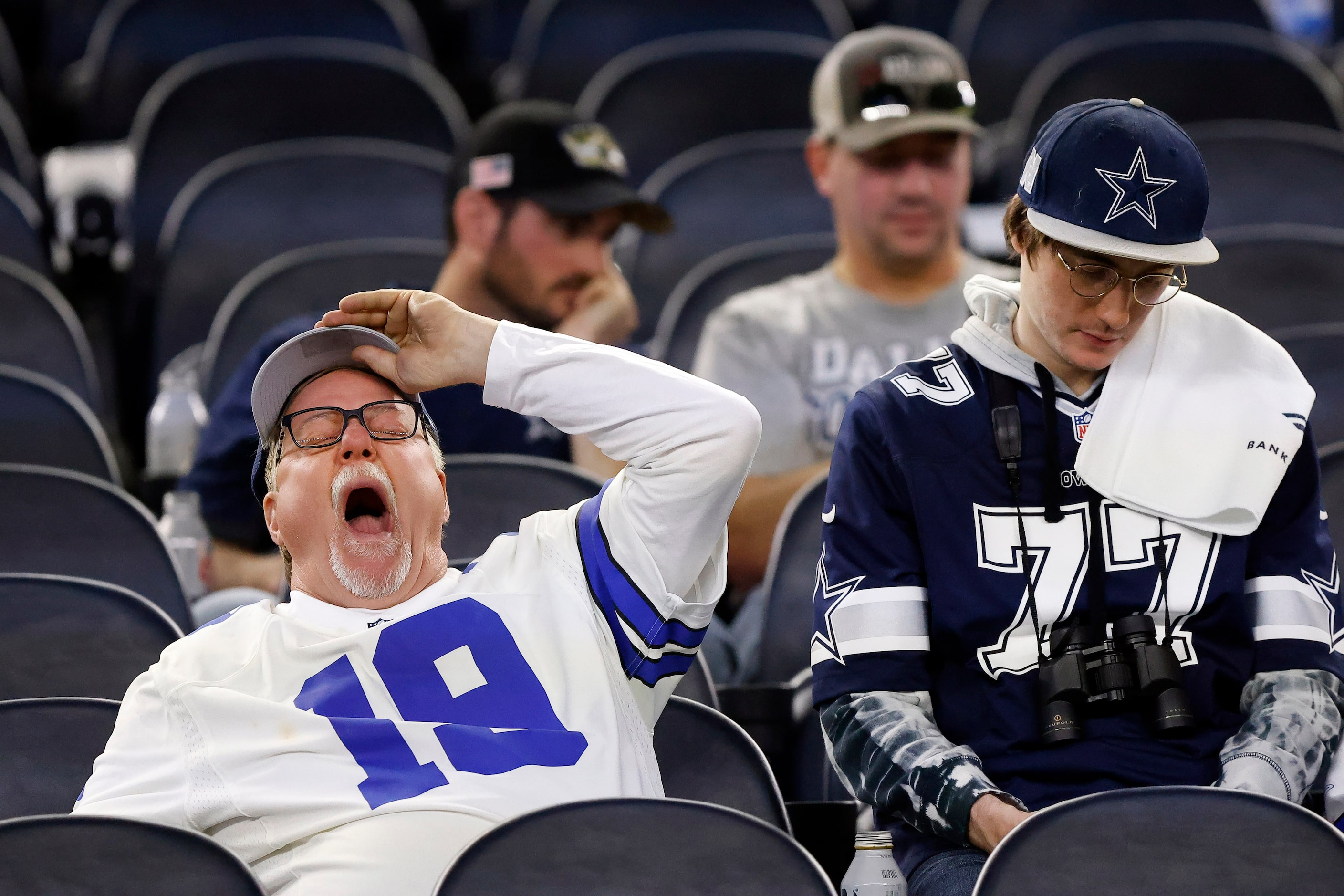 A Dallas Cowboys fan who stuck around after the NFL wild-card playoff game takes a big yawn...