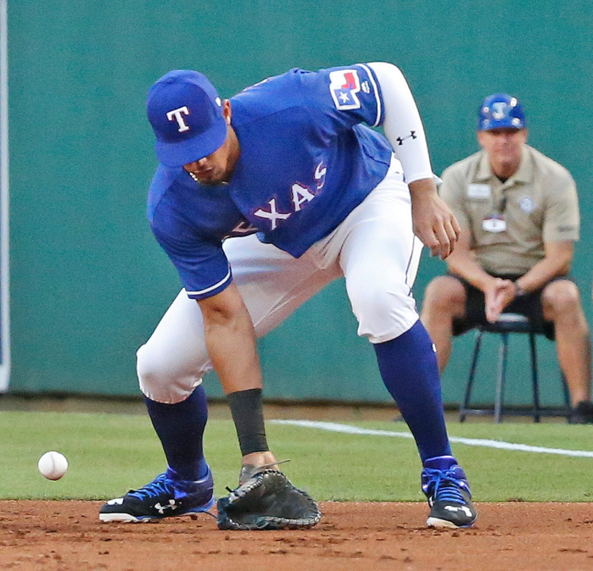 Texas Rangers first baseman Ronald Guzman (67) makes an error on Brett Gardner's grounder in...