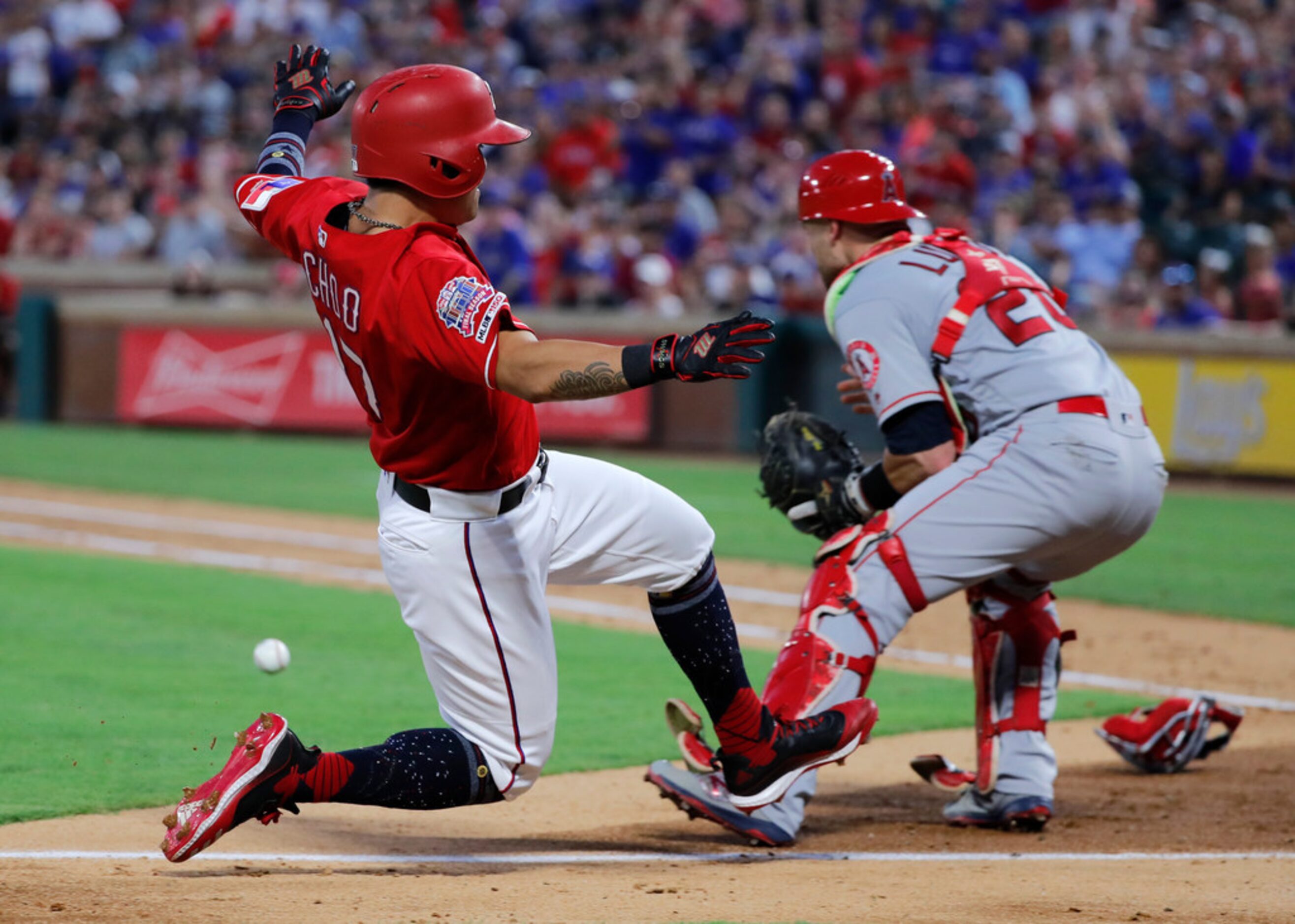 Texas Rangers' Shin-Soo Choo, left, slides ahead of the throw to Los Angeles Angels'...