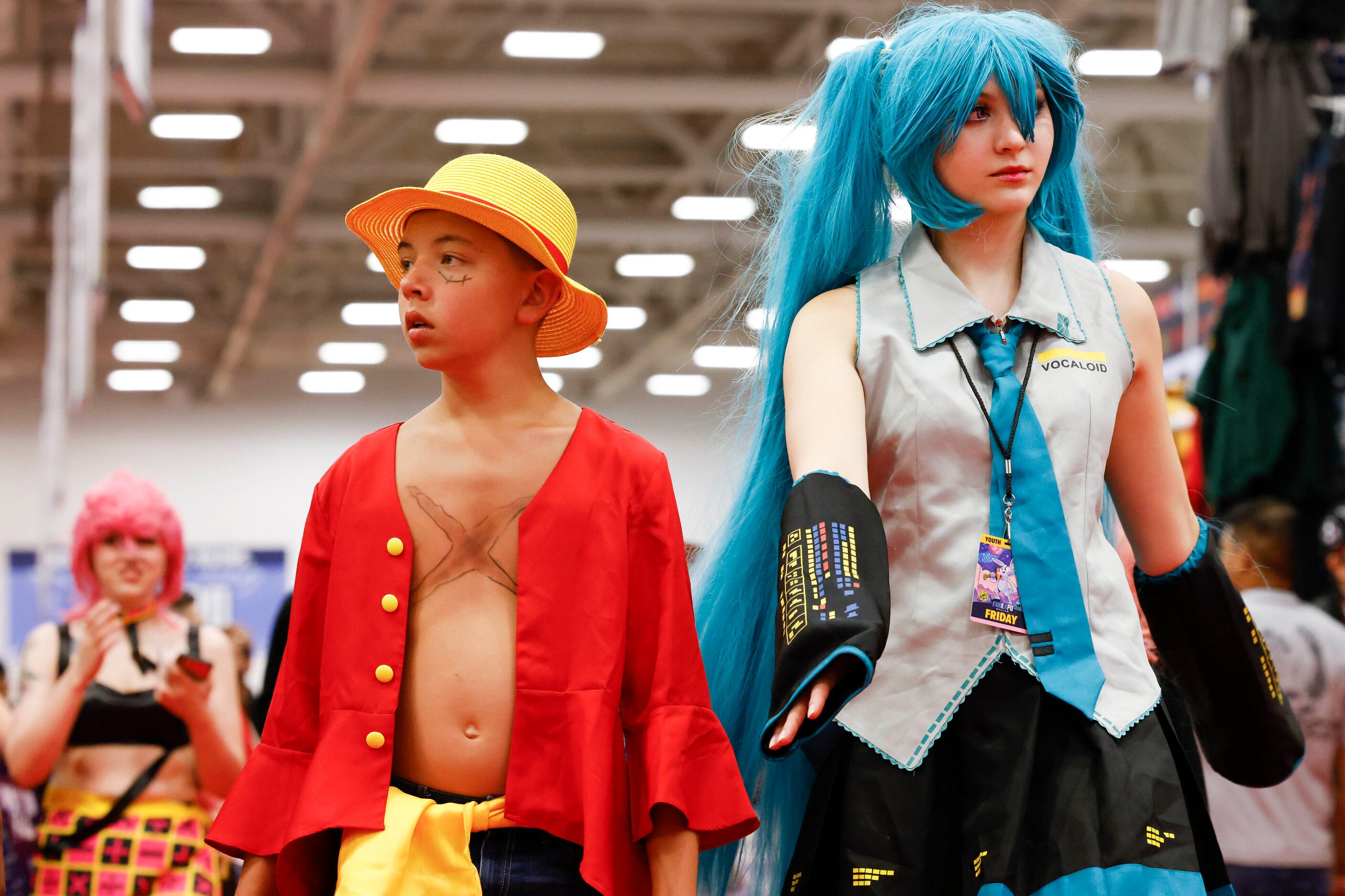 People wearing costumes walk around during Fan Expo Dallas on Friday, June 9, 2023, at Kay...