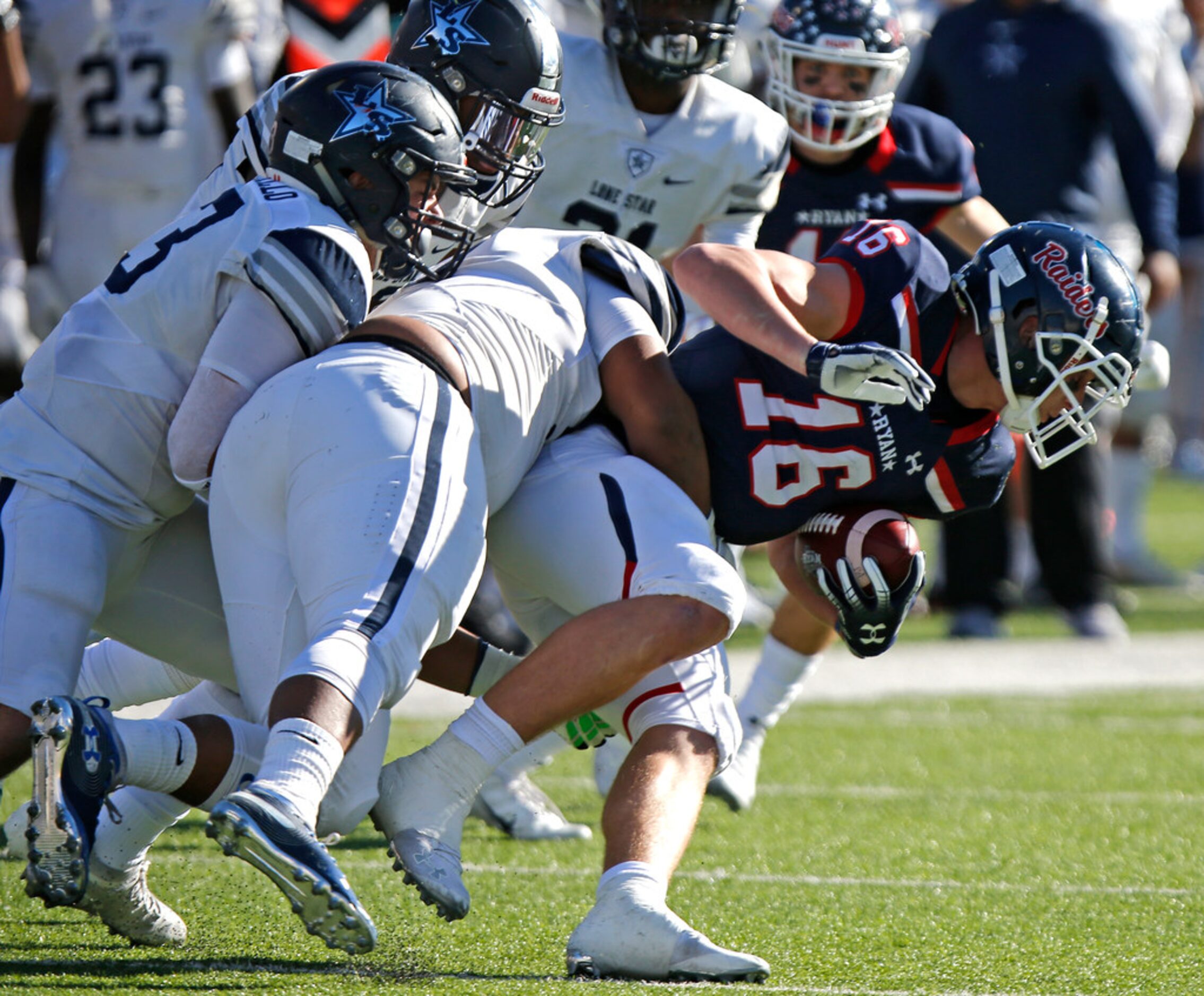 Denton Ryan High School wide receiver Drew Sanders (16) is brought down after a catch by a...