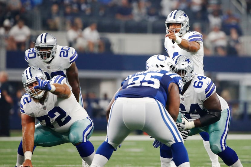 Dallas Cowboys quarterback Dak Prescott (4) communicates to his teammates before the snap...