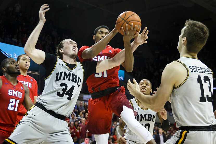 SMU guard Jimmy Whitt (31) is fouled by UMBC forward Max Portmann (34) during the second...