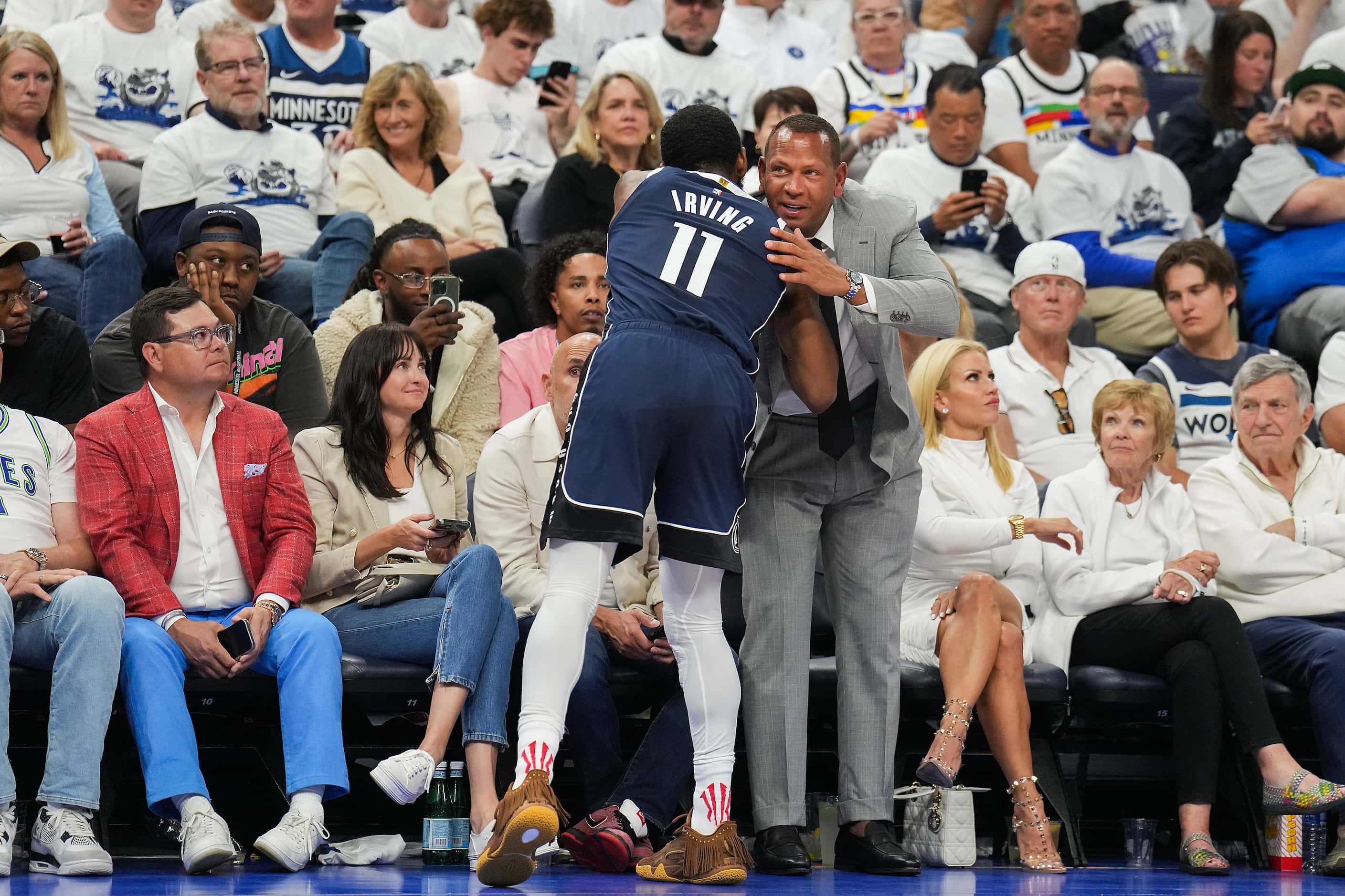Dallas Mavericks guard Kyrie Irving (11) hugs Minnesota Timberwolves part owner Alex...