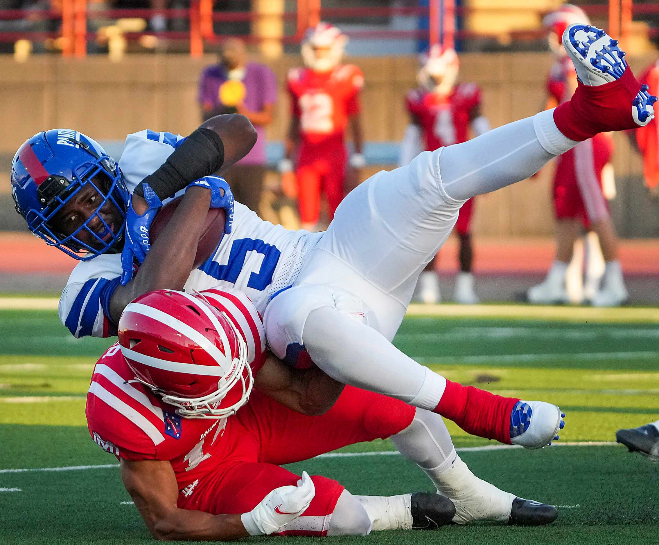 Duncanville running back Malachi Medlock (5) is knocked off his feet by Mater Dei defensive...