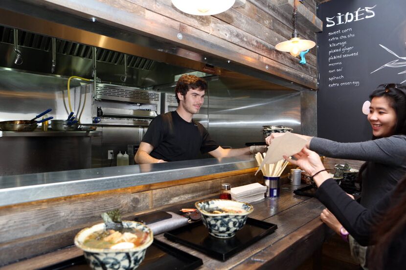 Christian Koelling delivers a bowl to customers at Ten in Dallas 