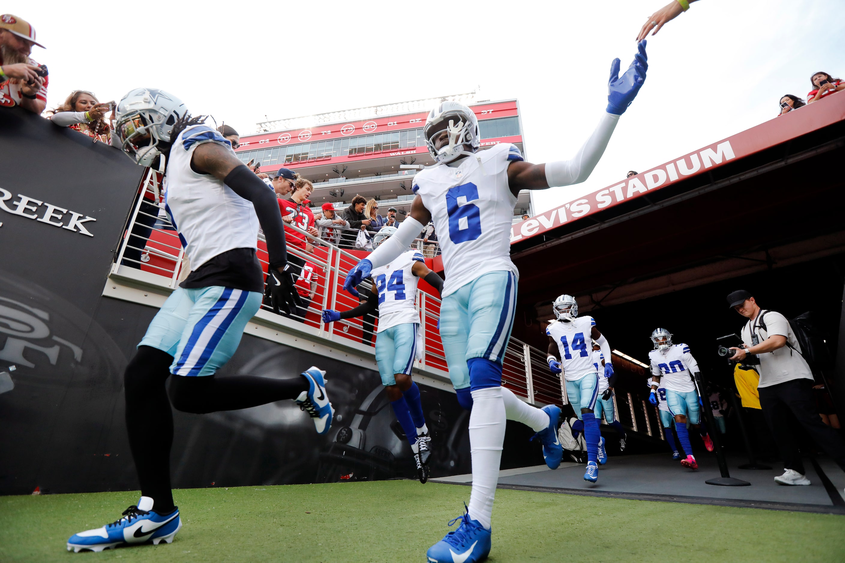 Dallas Cowboys safety Donovan Wilson (6) and cornerback Trevon Diggs (7) race onto the field...