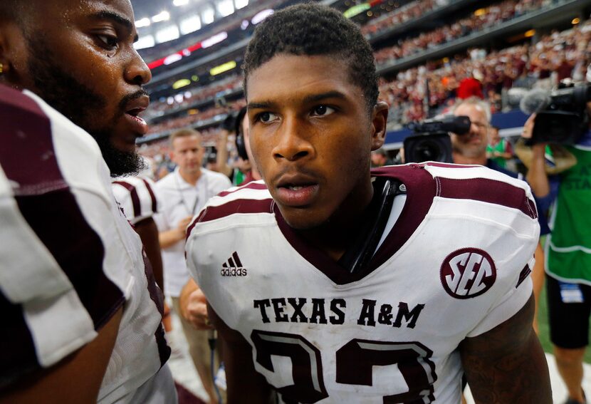 Texas A&M Aggies defensive back Armani Watts (23) is congratulated by teammates after...