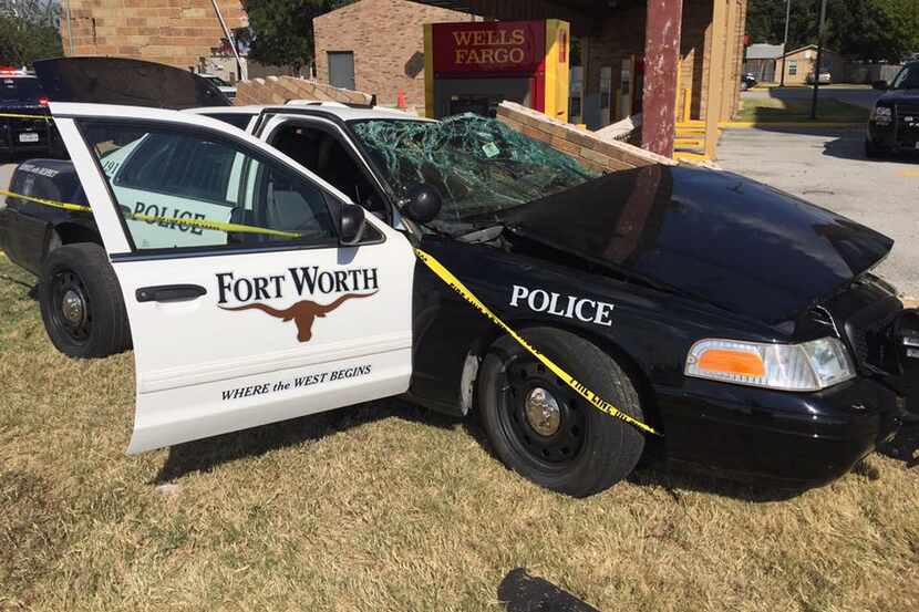 Two officers were rescued from their patrol car Sunday after crashing against a brick wall...