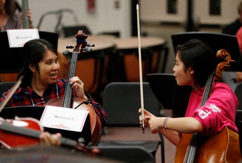 Monica Chi gets some instructional help from her daughter Julianne Chi, 14, during a...