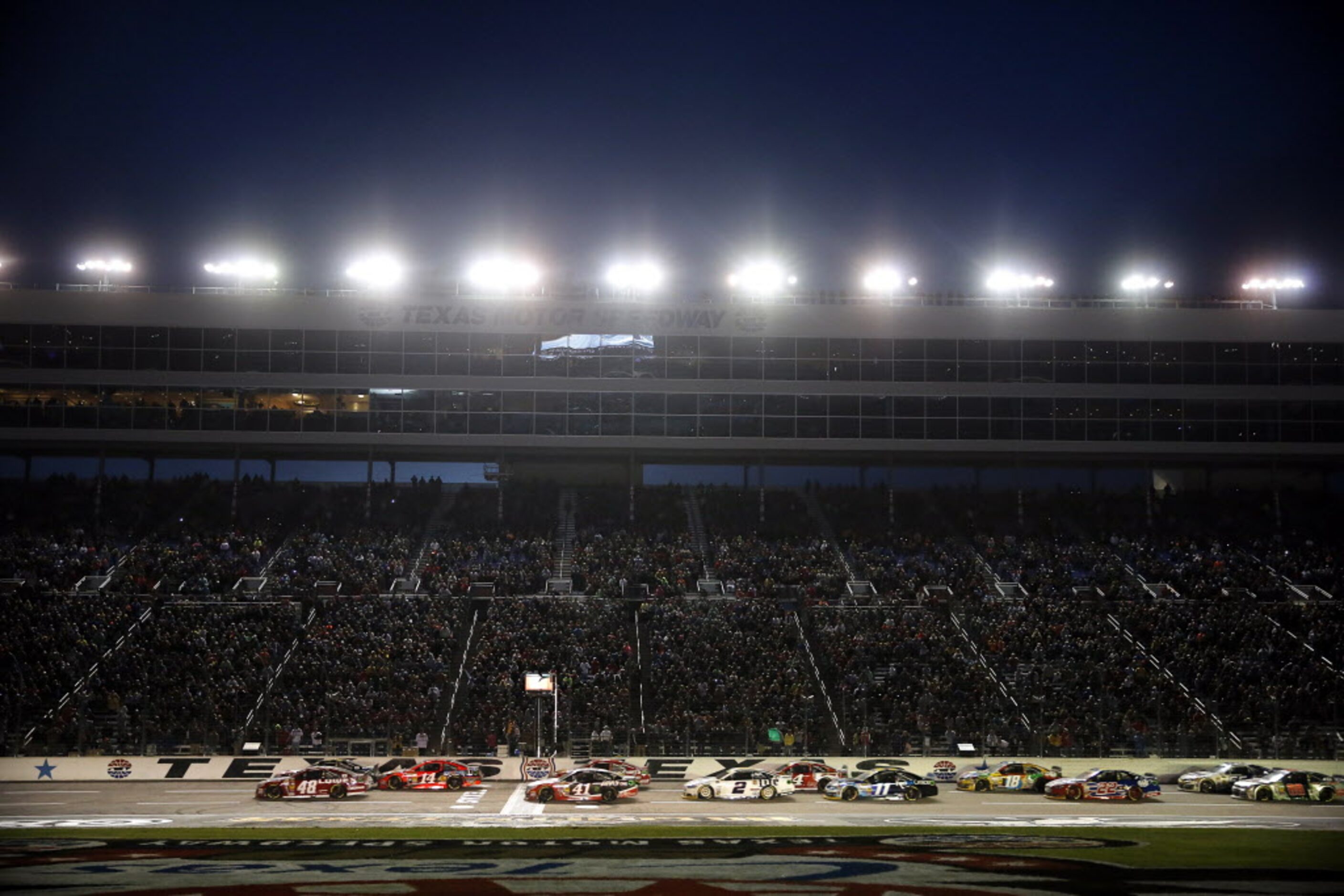 Sprint Cup Series driver Jimmie Johnson (48) leads the field of cars down the front stretch...