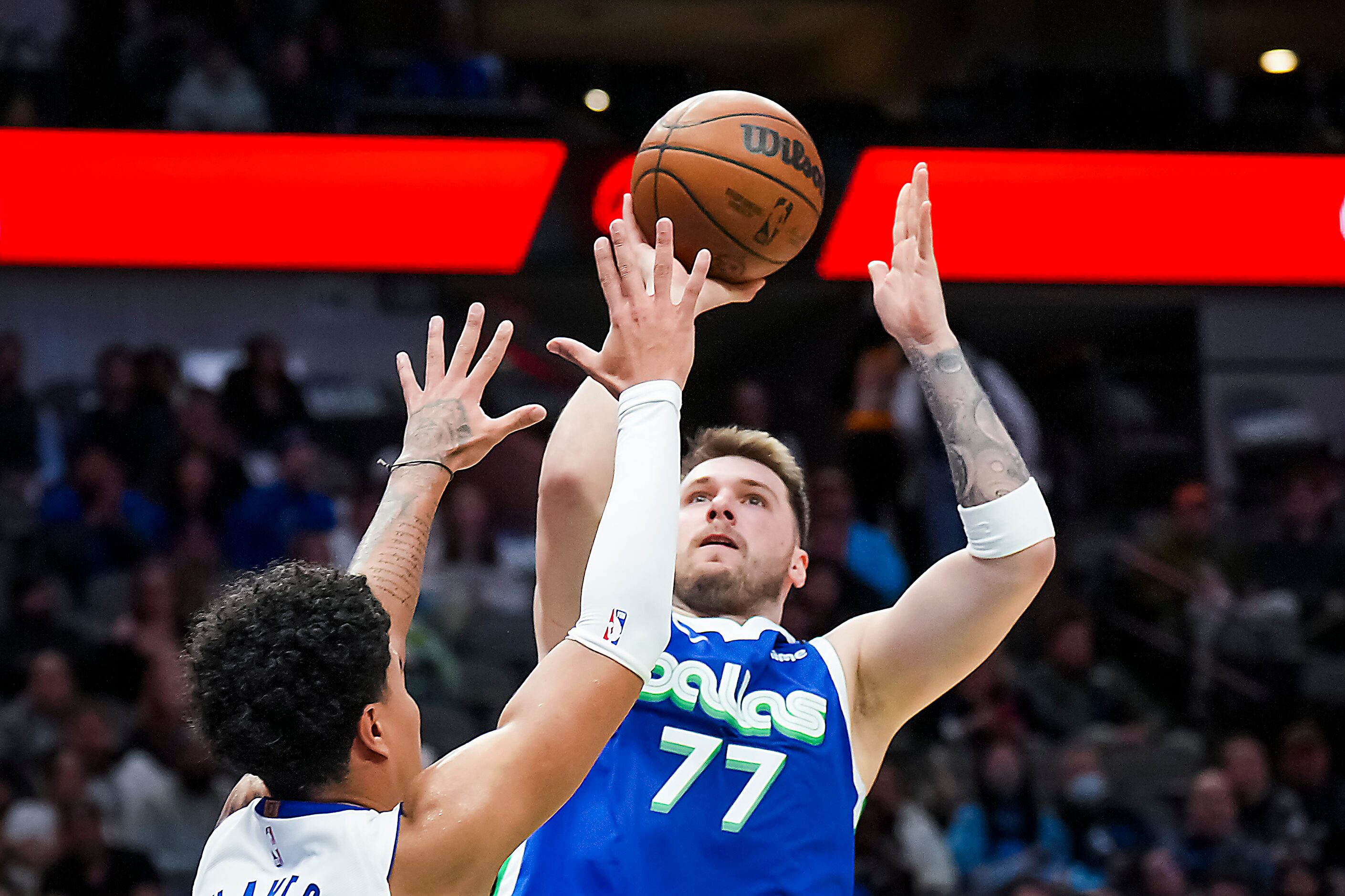 Dallas Mavericks guard Luka Doncic (77) shoots over Detroit Pistons guard Killian Hayes (7)...