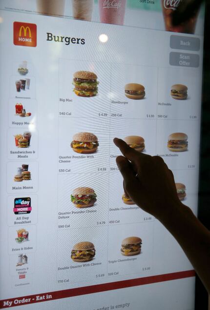 A customer orders food at a self-service kiosk at a McDonald's restaurant in Chicago....