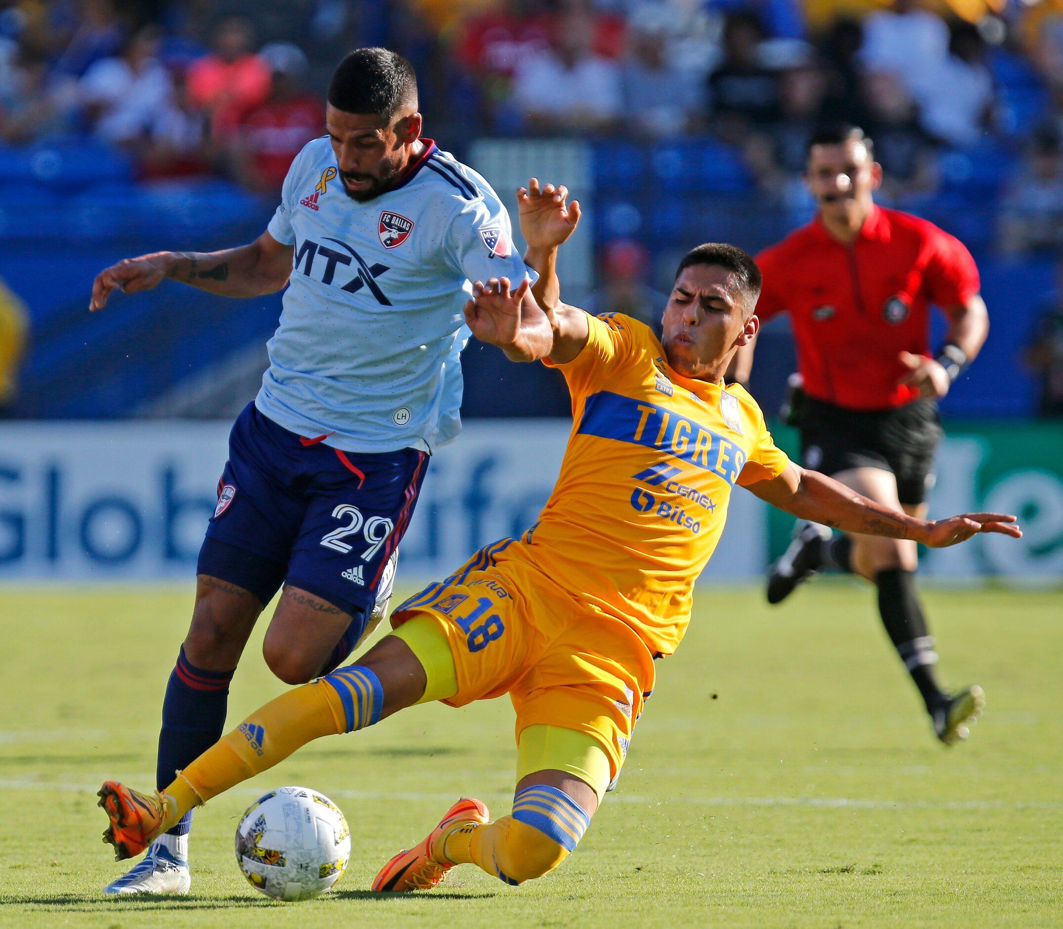 FC Dallas forward Franco Jara (29) is taken down by Tigres UANL midfielder David Ayala (18)...