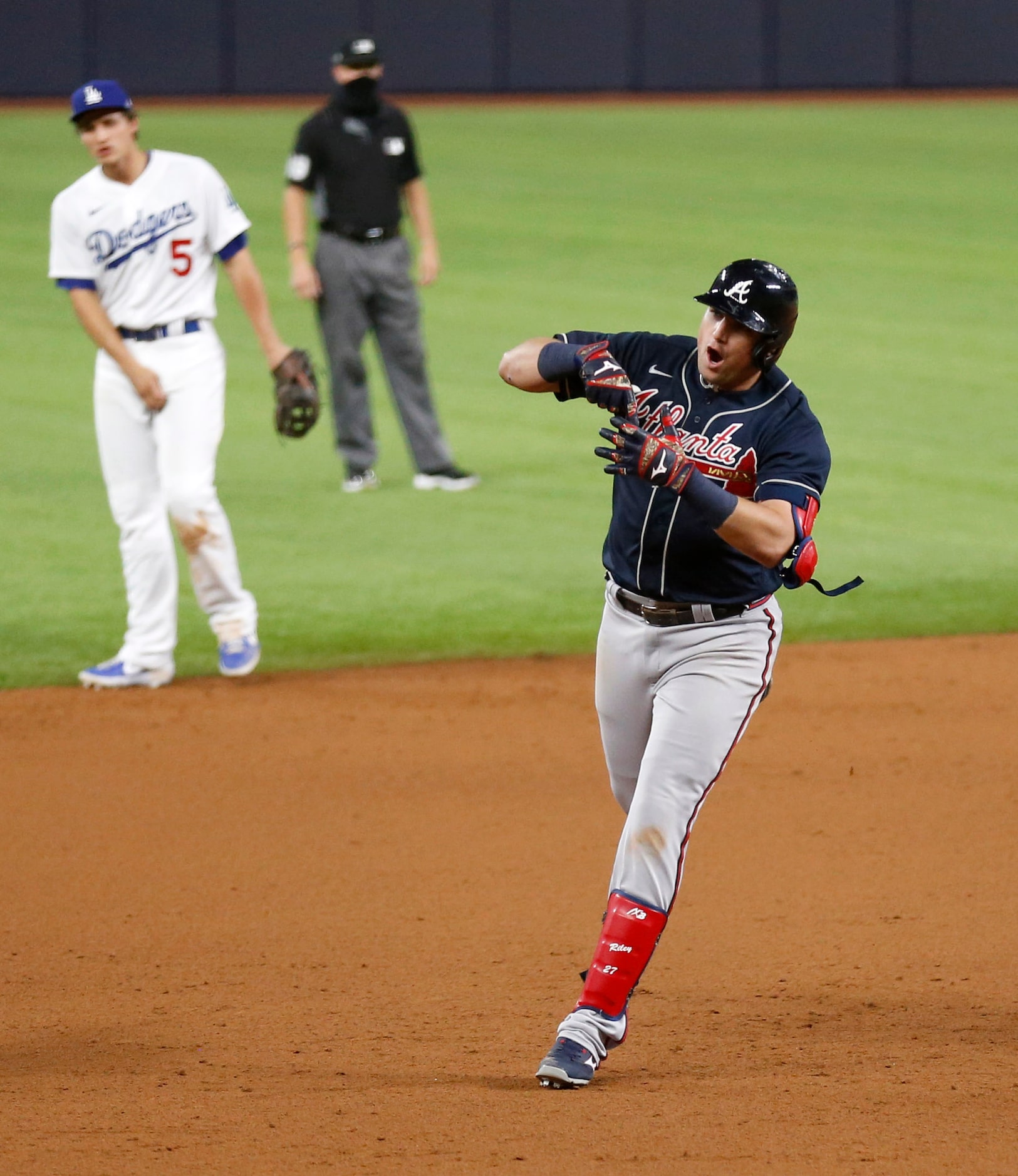 Atlanta Braves third baseman Austin Riley (27) rounds the bases after hitting a solo home...