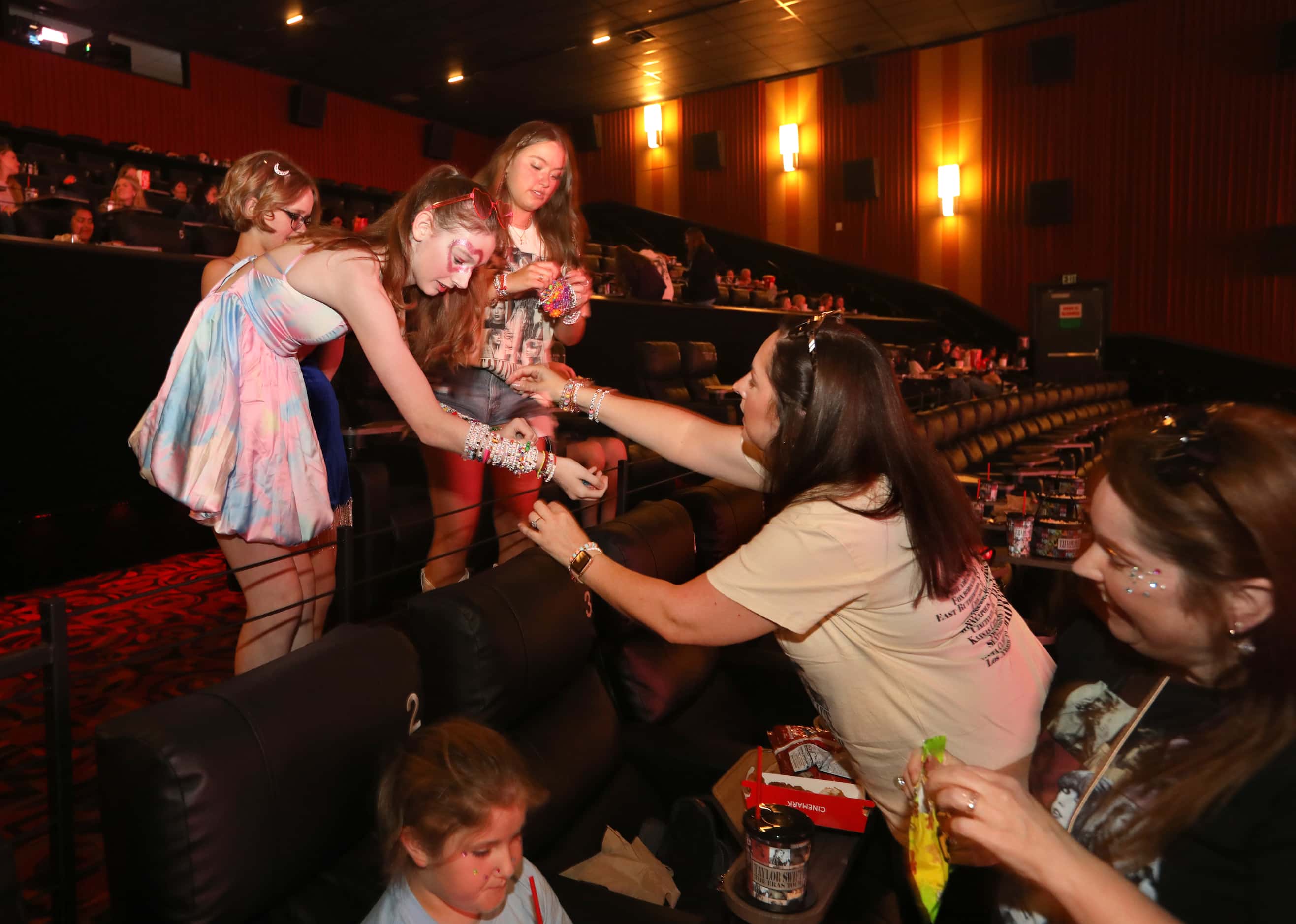 Taylor Swift fans trade friendship bracelets before her new film at Cinemark West Plano XD...