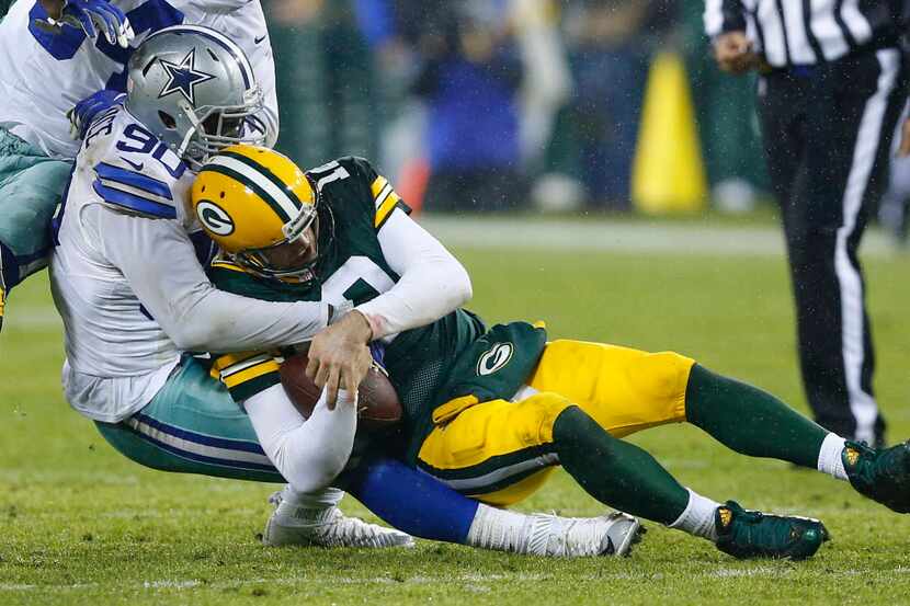 Dallas Cowboys defensive end Demarcus Lawrence (90) sacks Green Bay Packers quarterback...