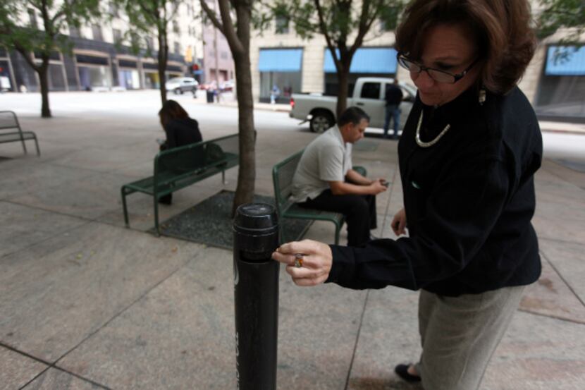 Vickie Thomas of IKON Office Solutions threw out her cigarette butt after a break at a...