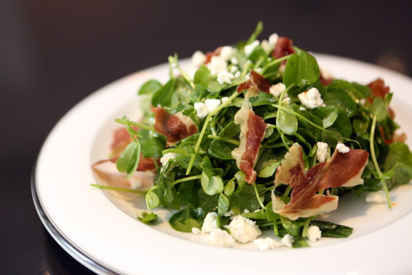 Pea shoot salad with crispy prosciutto and house-made ricotta at Cafe Momentum