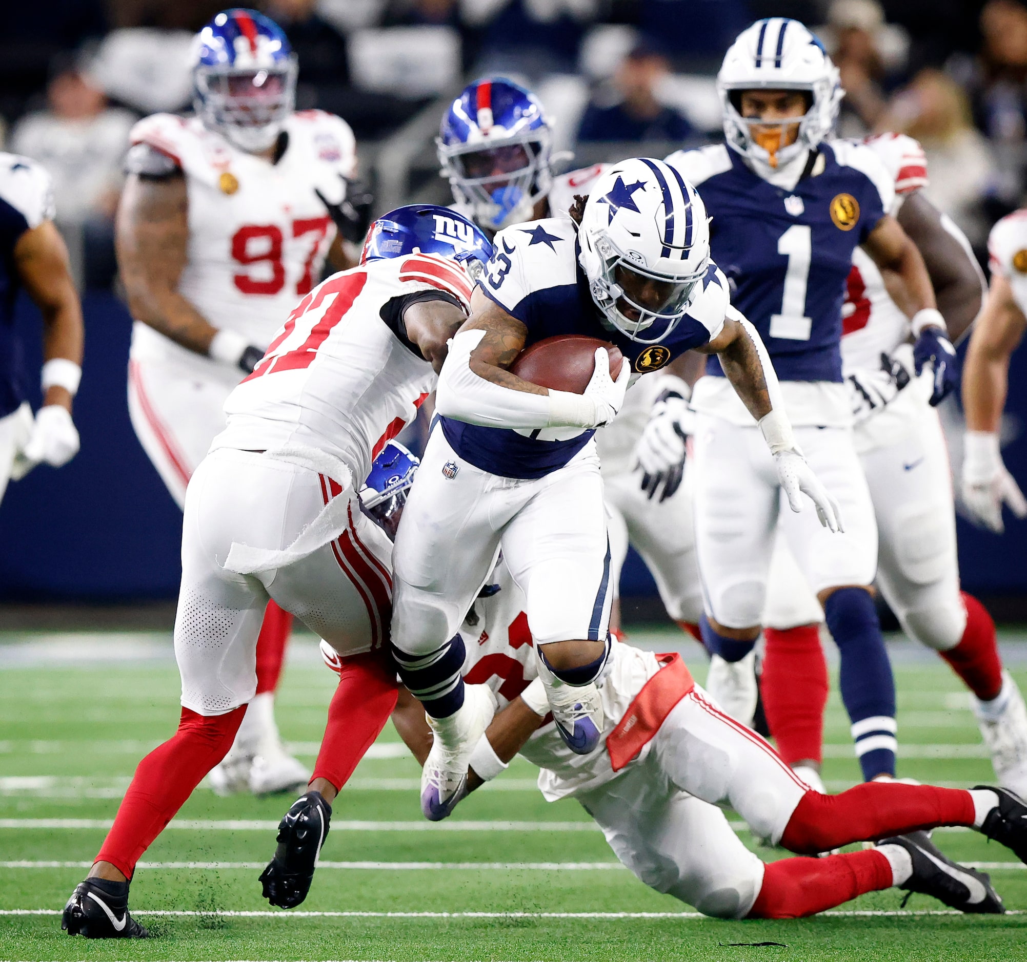 Dallas Cowboys running back Rico Dowdle (23) leaps through a sandwich tackle by New York...