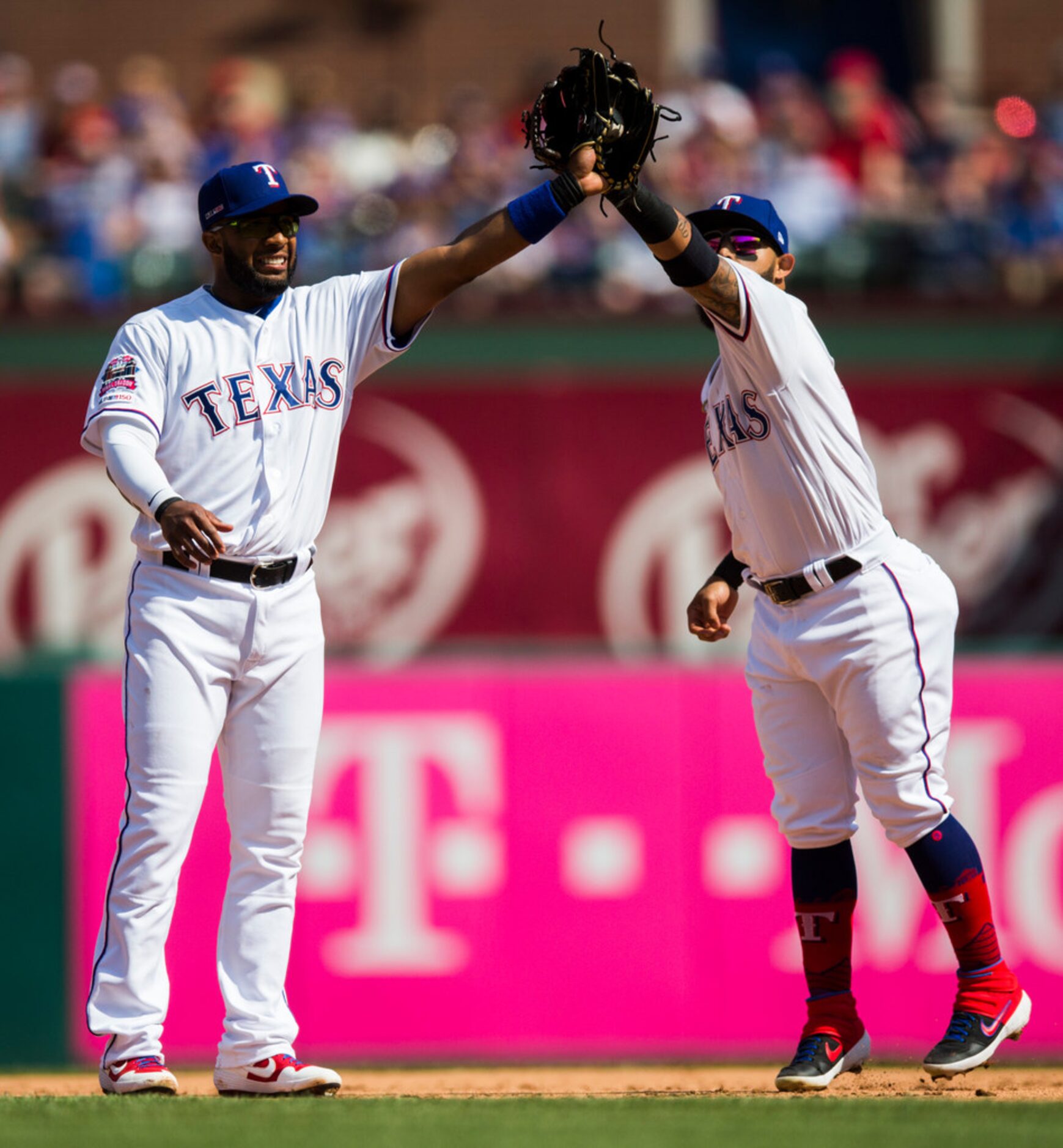 Texas Rangers shortstop Elvis Andrus (1) and second baseman Rougned Odor (12) reach to catch...