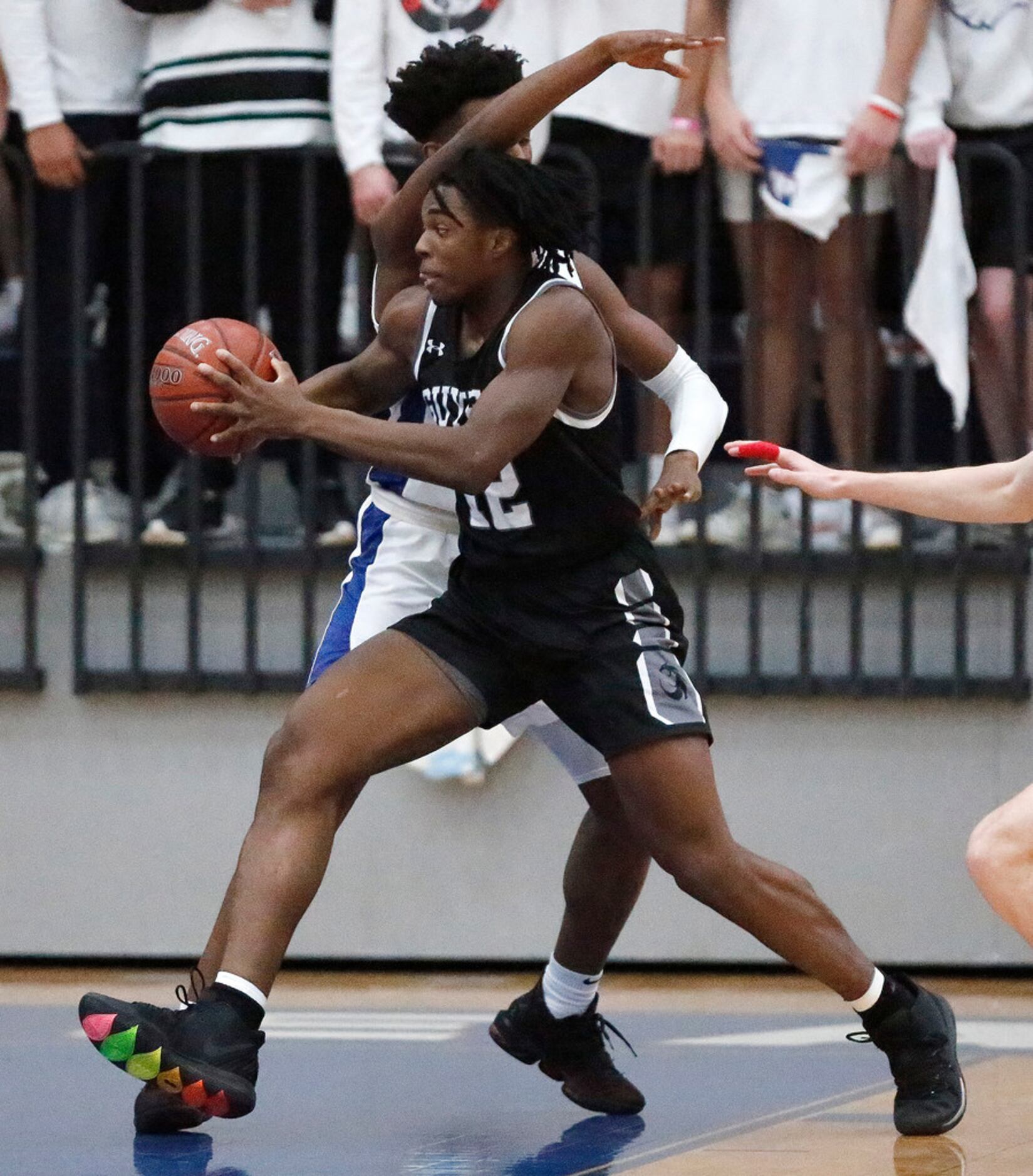 Denton Guyer High School's Amaechi Chukwu (12) attempts a move to the basket while Allen...