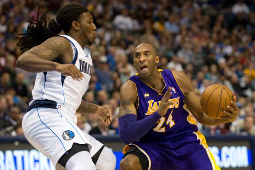 Kobe Bryant (24) of the Los Angeles Lakers drives to the basket against Jae Crowder (9) of...