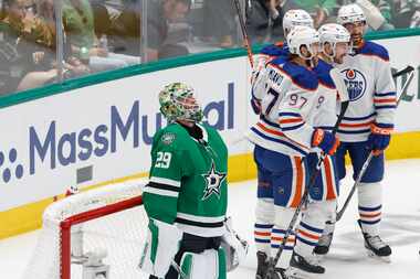 Dallas Stars goaltender Jake Oettinger (29) looks up as Edmonton Oilers players celebrates...