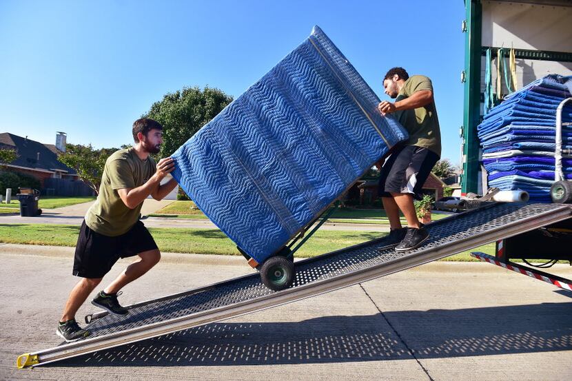 Movers load a truck in Denton in this 2015 file photo.