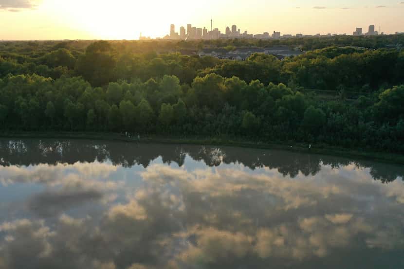 Aerial photography shows clouds reflecting on Parkdale Lake as well as the western side of...