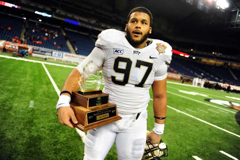 Pittsburgh Panthers defensive lineman Aaron Donald (97) holds the lineman of the game trophy...